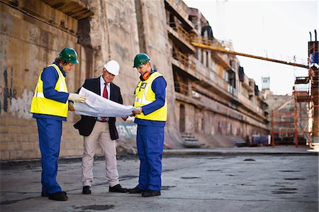 full body mature people profile - Workers reading blueprints on dry dock Stock Photo - Premium Royalty-Free, Code: 649-05950066