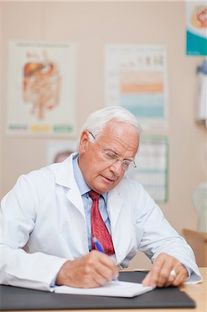 doctor with prescription - Doctor writing notes in office Stock Photo - Premium Royalty-Free, Code: 649-05950076