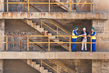 exterior design of commercial building - Workers talking on steps on dry dock Stock Photo - Premium Royalty-Free, Code: 649-05950070