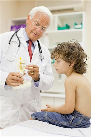 paediatrician (male) - Doctor showing boy model in office Stock Photo - Premium Royalty-Free, Code: 649-05950088