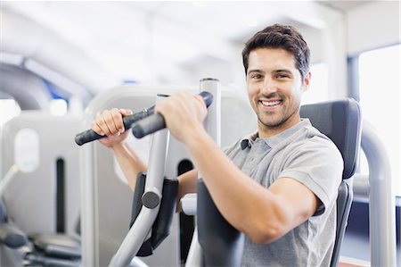 simsearch:649-05950164,k - Man using weights machine in gym Stock Photo - Premium Royalty-Free, Code: 649-05950157