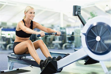 simsearch:649-05950164,k - Woman using rowing machine in gym Stock Photo - Premium Royalty-Free, Code: 649-05950188