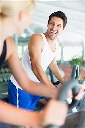 simsearch:649-05950199,k - Couple using exercise machines in gym Stock Photo - Premium Royalty-Free, Code: 649-05950196