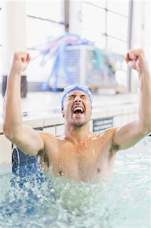 pictures of jumping in swimming pool - Swimmer cheering in pool Stock Photo - Premium Royalty-Free, Code: 649-05950222