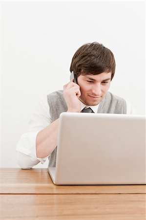 e-mail - Homme d'affaires avec ordinateur portable et téléphone cellulaire Photographie de stock - Premium Libres de Droits, Code: 649-05950250
