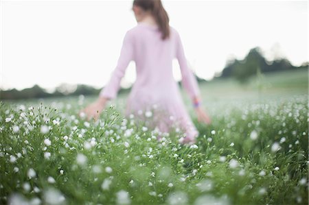 ponytail back view girl - Girl walking in field of flowers Stock Photo - Premium Royalty-Free, Code: 649-05950471