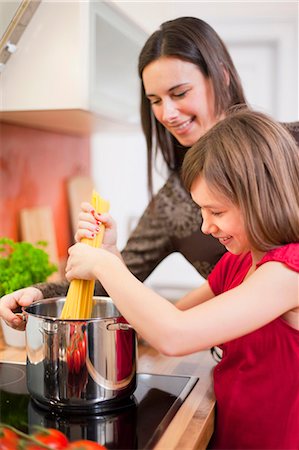 pots on a stove - Mother and daughter cooking together Stock Photo - Premium Royalty-Free, Code: 649-05950586