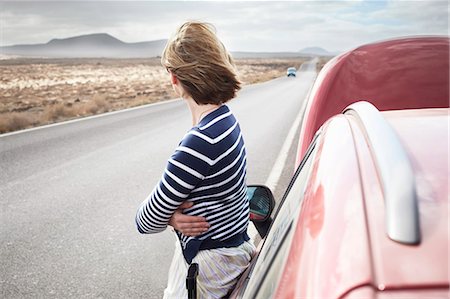 Woman with broken down car on rural road Stock Photo - Premium Royalty-Free, Code: 649-05950789