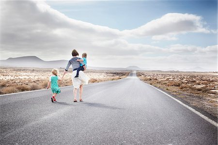 family holding hands with kids - Family walking on paved rural road Stock Photo - Premium Royalty-Free, Code: 649-05950794