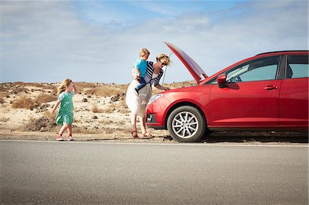 family problems - Mother examining broken down car Stock Photo - Premium Royalty-Free, Code: 649-05950800