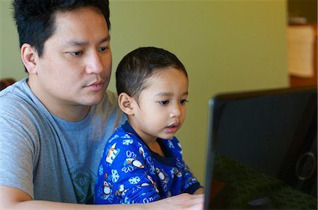 father children not grandparent asian - Father and son using computer together Stock Photo - Premium Royalty-Free, Code: 649-05950863