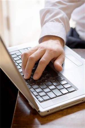 simsearch:649-03362975,k - Close up of businessman using laptop Stock Photo - Premium Royalty-Free, Code: 649-05951047