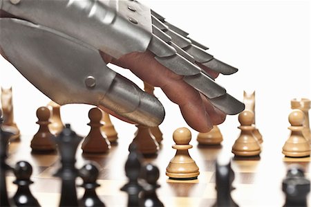 risk man - Close up of armored hand playing chess Stock Photo - Premium Royalty-Free, Code: 649-05951265