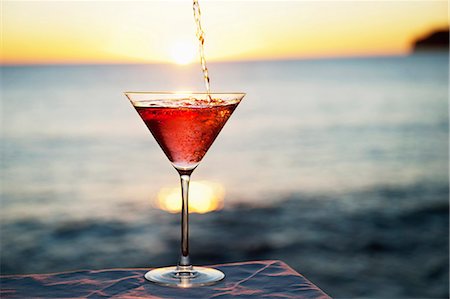 sunrise ocean - Cocktail pouring in glass outdoors Stock Photo - Premium Royalty-Free, Code: 649-06000402