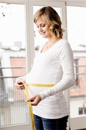 simsearch:649-06001093,k - Woman measuring pregnant belly Stock Photo - Premium Royalty-Free, Code: 649-06000425