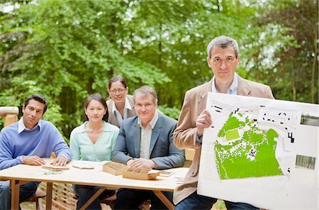 Businessman with map in meeting Stock Photo - Premium Royalty-Free, Code: 649-06000583