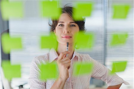 efficient - Businesswoman reading sticky notes Stock Photo - Premium Royalty-Free, Code: 649-06000838