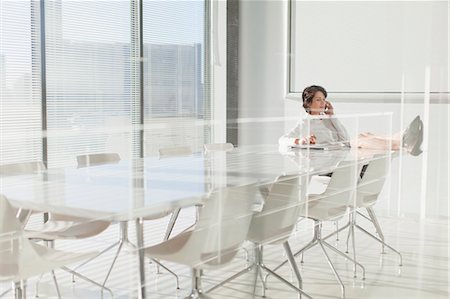 people at work conference room windows - Businesswoman talking on cell phone Stock Photo - Premium Royalty-Free, Code: 649-06000962