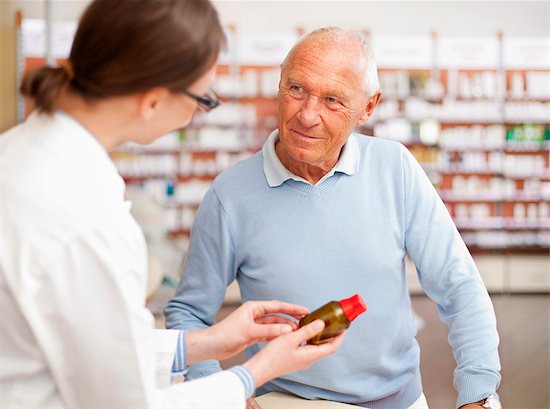 Pharmacist talking to patient in store Stock Photo - Premium Royalty-Free, Image code: 649-06001320