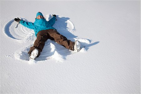 silly - Woman making snow angel on field Stock Photo - Premium Royalty-Free, Code: 649-06001352