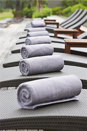 spa tranquility - Rolled towels on lawn chairs outdoors Stock Photo - Premium Royalty-Free, Code: 649-06001698