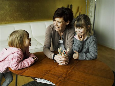 family playing games indoors - Mother and daughters playing together Stock Photo - Premium Royalty-Free, Code: 649-06001864