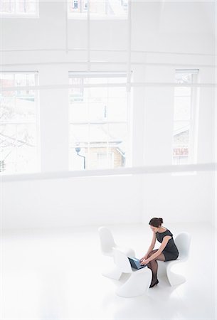 elevated view of a confident businesswoman - Businesswoman working in lobby area Stock Photo - Premium Royalty-Free, Code: 649-06001879