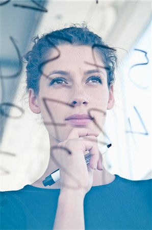 portrait business person close thinking not looking at camera - Businesswoman writing on glass Stock Photo - Premium Royalty-Free, Code: 649-06001872