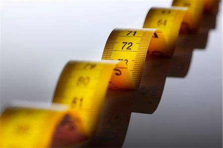 expand - Close up of measuring tape Stock Photo - Premium Royalty-Free, Code: 649-06002006