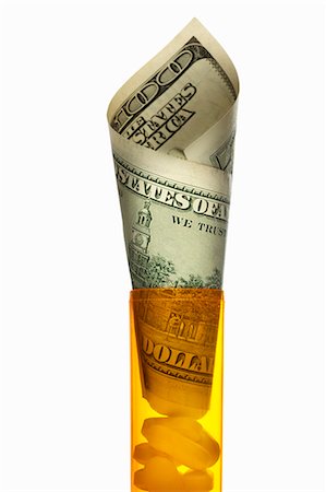 Close up of U.S. dollars in pill bottle Stock Photo - Premium Royalty-Free, Code: 649-06002010