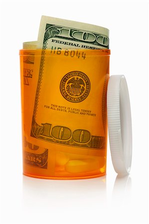 Close up of U.S. dollars in pill bottle Foto de stock - Sin royalties Premium, Código: 649-06002011