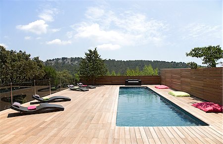 swimming pool deck - Lawn chairs and pool on modern deck Stock Photo - Premium Royalty-Free, Code: 649-06040059