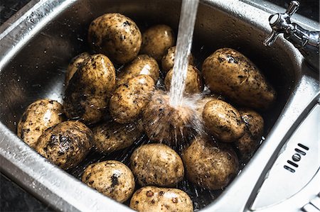 sale - Eau de rinçage des pommes de terre dans l'évier Photographie de stock - Premium Libres de Droits, Code: 649-06040082