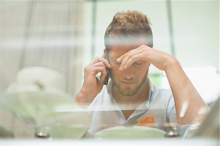 simsearch:649-06716954,k - Man talking on cell phone at breakfast Stock Photo - Premium Royalty-Free, Code: 649-06040109