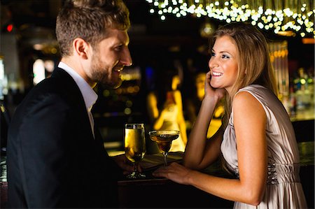 elegant woman sitting - Smiling couple having drinks at bar Stock Photo - Premium Royalty-Free, Code: 649-06040182