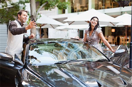 simsearch:649-06040250,k - Couple climbing out of car Stock Photo - Premium Royalty-Free, Code: 649-06040245