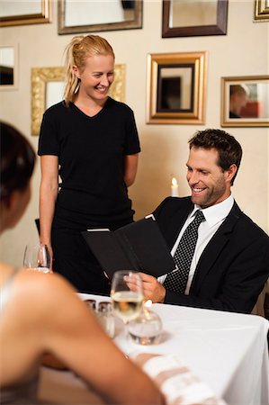 people standing at a dinner table - Couple ordering dinner in restaurant Stock Photo - Premium Royalty-Free, Code: 649-06040277