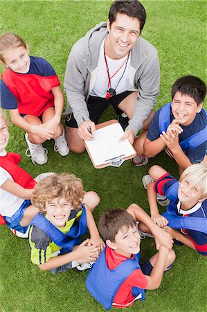 people huddling - Coach talking to childrens soccer team Stock Photo - Premium Royalty-Free, Code: 649-06040310