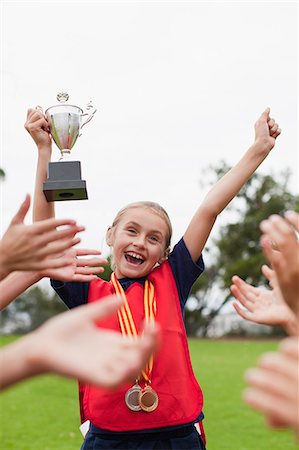 simsearch:649-06040320,k - Children cheering teammate with trophy Stock Photo - Premium Royalty-Free, Code: 649-06040325