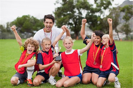 simsearch:649-06040320,k - Children cheering with coach Stock Photo - Premium Royalty-Free, Code: 649-06040320