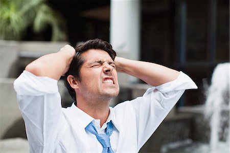 disappointment - Businessman tearing at his hair Stock Photo - Premium Royalty-Free, Code: 649-06040343