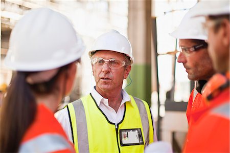 Workers walking at oil refinery Stock Photo - Premium Royalty-Free, Code: 649-06040387