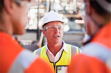 Workers walking at oil refinery Stock Photo - Premium Royalty-Free, Code: 649-06040388