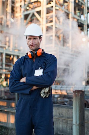 Worker standing at oil refinery Stock Photo - Premium Royalty-Free, Code: 649-06040429