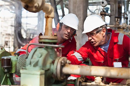 Workers examining equipment on site Stock Photo - Premium Royalty-Free, Code: 649-06040465