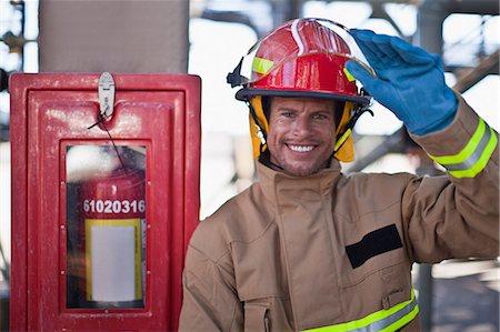 Firefighter smiling on site Stock Photo - Premium Royalty-Free, Code: 649-06040488