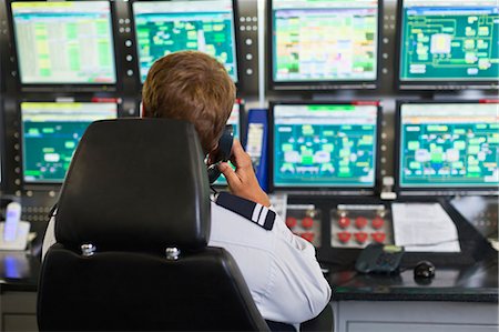 simsearch:6122-07706288,k - Man working in security control room Stock Photo - Premium Royalty-Free, Code: 649-06040497