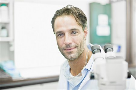 scientist looking at camera - Scientist smiling in lab Stock Photo - Premium Royalty-Free, Code: 649-06040534