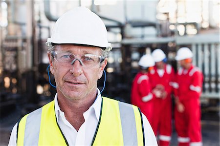 Worker standing at chemical plant Stock Photo - Premium Royalty-Free, Code: 649-06040556