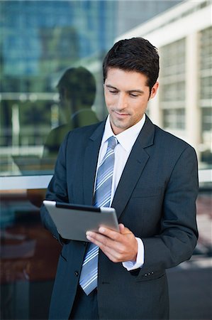 suit man at window - Businessman using tablet computer Stock Photo - Premium Royalty-Free, Code: 649-06040596